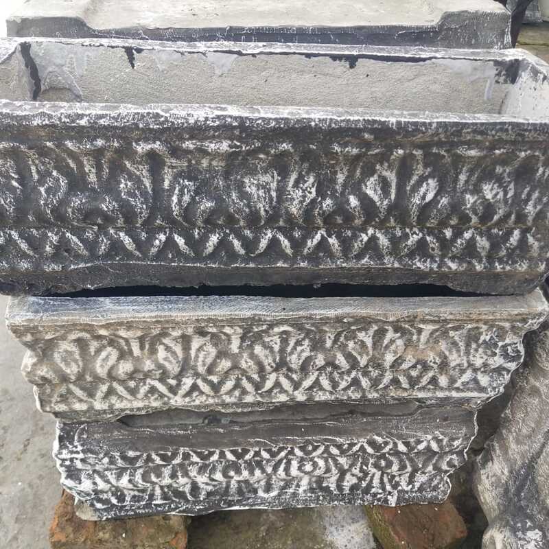 Stone planter box with ornate detailing